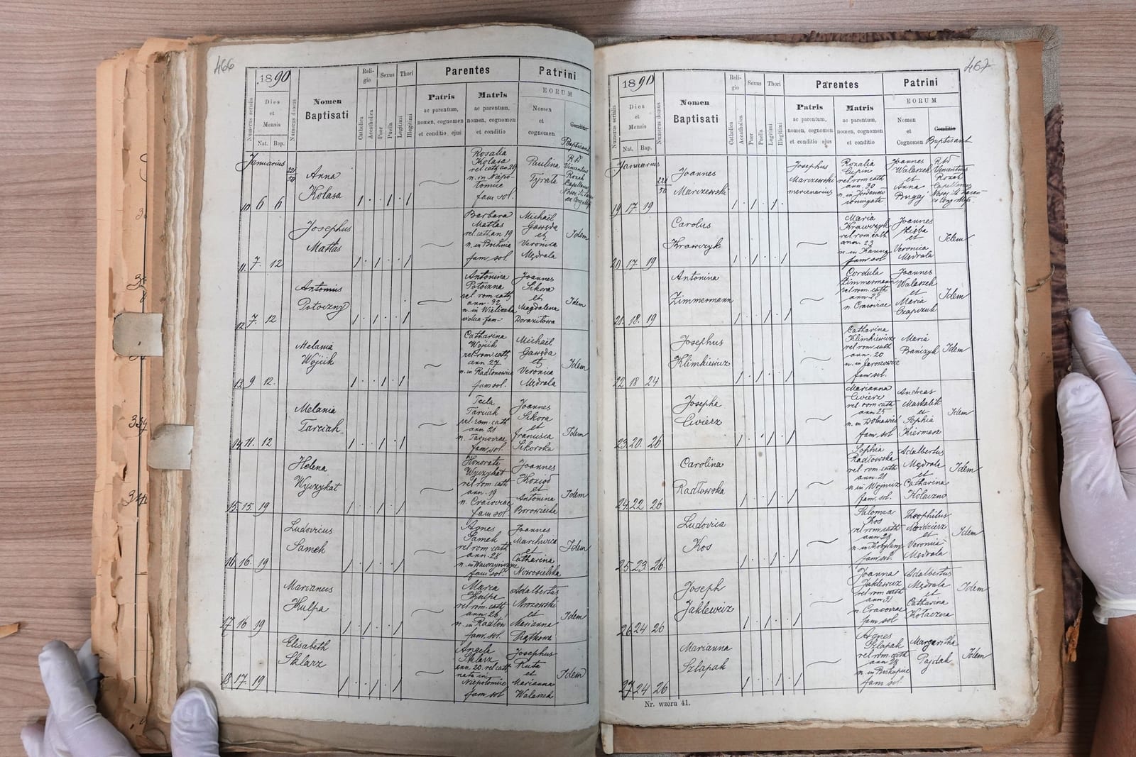 An open parish register with handwritten Latin entries recording 19th-century baptisms.