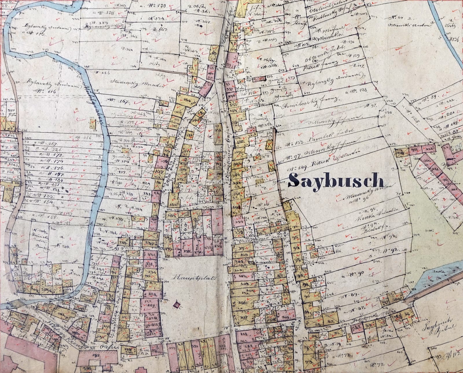 A 19th-century colour-coded cadastral map of a Galician village with numbered parcels and owners’ names.